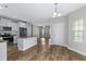 Open-concept kitchen and dining area featuring white cabinets, stainless steel appliances, and seamless access to the living spaces at 104 Browns Hollow Ct., Loris, SC 29569