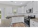 Bright kitchen features white cabinetry, stainless steel appliances, granite countertops, and sleek hardware, offering ample space at 104 Browns Hollow Ct., Loris, SC 29569