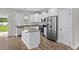 Modern kitchen features white cabinets, stainless steel appliances, and a granite island at 104 Browns Hollow Ct., Loris, SC 29569