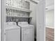 Laundry room featuring a washer, dryer, decorative wallpaper, and shelving at 104 Browns Hollow Ct., Loris, SC 29569
