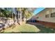 Landscaped backyard features a stone patio, stairs leading to the deck, and perimeter fencing at 1089 Weslin Creek Dr., Myrtle Beach, SC 29588