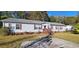 Traditional single-story home with a concrete driveway, wood porch, and classic shutters at 1089 Weslin Creek Dr., Myrtle Beach, SC 29588
