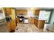 This kitchen features wood cabinets, stainless steel appliances, and easy access to the backyard through a sliding door at 1089 Weslin Creek Dr., Myrtle Beach, SC 29588