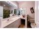 Well-lit bathroom with a spacious vanity, large mirrors, and a golf-themed shower curtain at 1101 Peace Pipe Pl. # 104, Myrtle Beach, SC 29579
