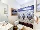Bathroom with golf-themed art, a golf shower curtain, and a golf-themed mirror at 1101 Peace Pipe Pl. # 104, Myrtle Beach, SC 29579