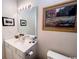 Cozy bathroom featuring a vanity with a single sink, a framed mirror, and tasteful golf-themed decor at 1101 Peace Pipe Pl. # 104, Myrtle Beach, SC 29579