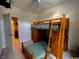 This bedroom features a wooden bunkbed with built-in drawers and desk, perfect for maximizing space and functionality at 1101 Peace Pipe Pl. # 104, Myrtle Beach, SC 29579