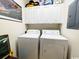 Functional laundry room equipped with a washer and dryer and overhead storage cabinets at 1101 Peace Pipe Pl. # 104, Myrtle Beach, SC 29579