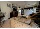 Inviting living room featuring plush sofas, a ceiling fan, and a doorway leading to another room at 1101 Peace Pipe Pl. # 104, Myrtle Beach, SC 29579