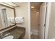 Bright bathroom featuring granite counters, a shower, a toilet, and fresh towels at 1105 S Ocean Blvd. # 932, Myrtle Beach, SC 29577