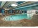 Bright indoor pool area with lounge chairs, seating, and unique architecture with pops of blue at 1105 S Ocean Blvd. # 932, Myrtle Beach, SC 29577