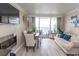 Well-lit living and dining area leading to a balcony with stunning waterfront views at 1105 S Ocean Blvd. # 932, Myrtle Beach, SC 29577