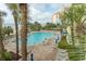 Gorgeous outdoor pool surrounded by palm trees, lounge chairs, and views of the beach and ocean at 1105 S Ocean Blvd. # 932, Myrtle Beach, SC 29577