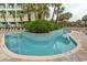 Inviting outdoor pool area surrounded by lush greenery, palm trees, and lounge chairs at 1105 S Ocean Blvd. # 932, Myrtle Beach, SC 29577