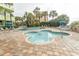 Inviting outdoor pool area surrounded by lush greenery, palm trees, and lounge chairs at 1105 S Ocean Blvd. # 932, Myrtle Beach, SC 29577