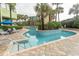 Inviting outdoor pool area surrounded by lush greenery, palm trees, and lounge chairs at 1105 S Ocean Blvd. # 932, Myrtle Beach, SC 29577