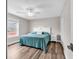 This bedroom boasts wood floors, a ceiling fan, and a decorative headboard at 1119 S Ocean Blvd. # 8, Surfside Beach, SC 29575