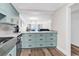 A modern kitchen featuring sleek cabinets, stainless steel appliances, and an open design flowing into the living area at 1119 S Ocean Blvd. # 8, Surfside Beach, SC 29575