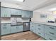 Well-equipped kitchen features blue cabinetry and stainless steel appliances at 1119 S Ocean Blvd. # 8, Surfside Beach, SC 29575