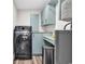Well-equipped laundry room with modern washer/dryer, storage cabinets, and a utility sink for added convenience at 1119 S Ocean Blvd. # 8, Surfside Beach, SC 29575