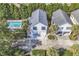 An aerial view of a stilt home in a community with a swimming pool and mature landscaping at 1125 Camellia Dr., Surfside Beach, SC 29575