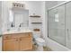 Clean bathroom with glass enclosed shower, vanity with storage, and decorative mirror at 1125 Camellia Dr., Surfside Beach, SC 29575