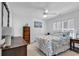 Bright bedroom featuring beach-themed bedding, a ceiling fan, and shuttered windows at 1125 Camellia Dr., Surfside Beach, SC 29575
