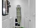 Compact laundry room with washing machine, ironing board, and storage space for convenience at 1125 Camellia Dr., Surfside Beach, SC 29575