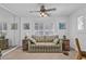 Bright living room with hardwood floors, ceiling fan, large windows, and access to a second room at 1125 Camellia Dr., Surfside Beach, SC 29575