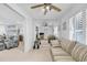 Bright living room with mirrored wall, hardwood floors, ceiling fan, and access to other living spaces at 1125 Camellia Dr., Surfside Beach, SC 29575