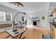 Living room featuring hardwood floors, shuttered windows, a ceiling fan, and partial kitchen view at 1125 Camellia Dr., Surfside Beach, SC 29575