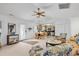 Bright living room with ceiling fan, dining table, and access to the kitchen with stainless steel appliances at 1125 Camellia Dr., Surfside Beach, SC 29575