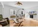 Living room featuring hardwood floors, shuttered windows, and a ceiling fan at 1125 Camellia Dr., Surfside Beach, SC 29575