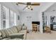 Bright living room features a ceiling fan, white plantation shutters, comfortable seating and a convenient workspace at 1125 Camellia Dr., Surfside Beach, SC 29575