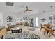 Bright living room with hardwood floors, ceiling fan, large windows, and access to a breakfast area at 1125 Camellia Dr., Surfside Beach, SC 29575