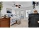 Cozy main bedroom with soft carpet, ceiling fan, television, and windows with plantation shutters at 1125 Camellia Dr., Surfside Beach, SC 29575