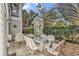 Outdoor patio features comfortable wicker furniture, a glass table, and a charming storage shed at 1125 Camellia Dr., Surfside Beach, SC 29575
