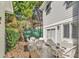 Cozy outdoor patio features comfortable white wicker furniture, privacy landscaping, and a relaxing ambiance at 1125 Camellia Dr., Surfside Beach, SC 29575