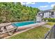 Backyard features a sparkling pool, poolside seating, lush landscaping, and mature trees at 1125 Camellia Dr., Surfside Beach, SC 29575
