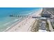 A picturesque aerial view of a sandy beach leading to a pier, with the ocean and townhouses stretching along the coastline at 1200 5Th Ave. N # 1207, Surfside Beach, SC 29575