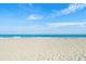 Expansive view of a pristine beach with clear blue water and white sand, creating a tranquil and inviting atmosphere at 1200 5Th Ave. N # 1207, Surfside Beach, SC 29575