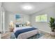 Well-lit bedroom features a bed with blue accents, and a window view to the outside at 1200 5Th Ave. N # 1207, Surfside Beach, SC 29575