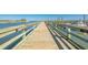 Scenic pier with wooden railings offering stunning water views, ideal for fishing and enjoying the coastal scenery at 1200 5Th Ave. N # 1207, Surfside Beach, SC 29575