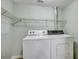 Laundry room with white washer and dryer and wire shelving for storage at 1200 5Th Ave. N # 1207, Surfside Beach, SC 29575