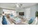 Bright living room with ceiling fan, white furniture, and view into adjacent kitchen at 1200 5Th Ave. N # 1207, Surfside Beach, SC 29575