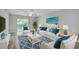 Bright living room with beach-themed decor, ceiling fan, and sliding glass doors to balcony at 1200 5Th Ave. N # 1207, Surfside Beach, SC 29575