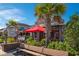 Charming exterior of a restaurant with a rustic design, lush greenery, and inviting outdoor seating at 1200 5Th Ave. N # 1207, Surfside Beach, SC 29575