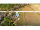 Aerial view of home on a large lot surrounded by farm land and a wooded area at 1200 Bergen Dr., Loris, SC 29569