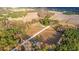 Aerial view of home surrounded by farm land, wooded areas and a rural neighborhood at 1200 Bergen Dr., Loris, SC 29569