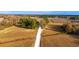Aerial view of property with long driveway surrounded by farmland and mature trees at 1200 Bergen Dr., Loris, SC 29569